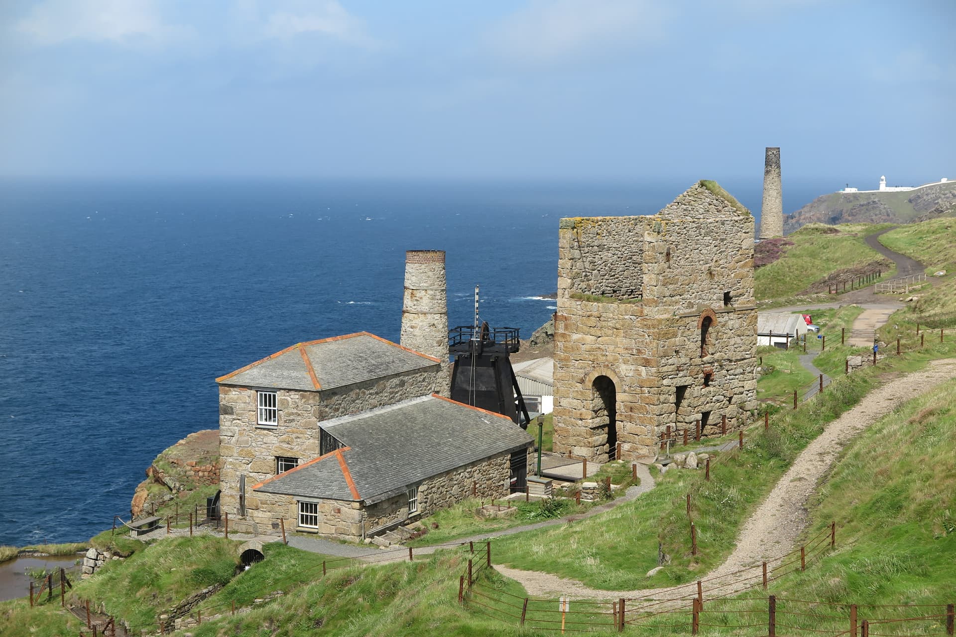 Stone engine houses on grassy cliff overlooking the deep blue sea, Zennor, Cornwall.
