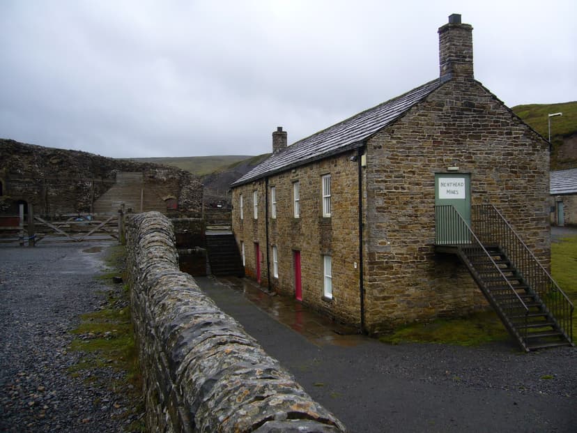 Historic stone building with Nenthead Mines sign and outdoor staircase