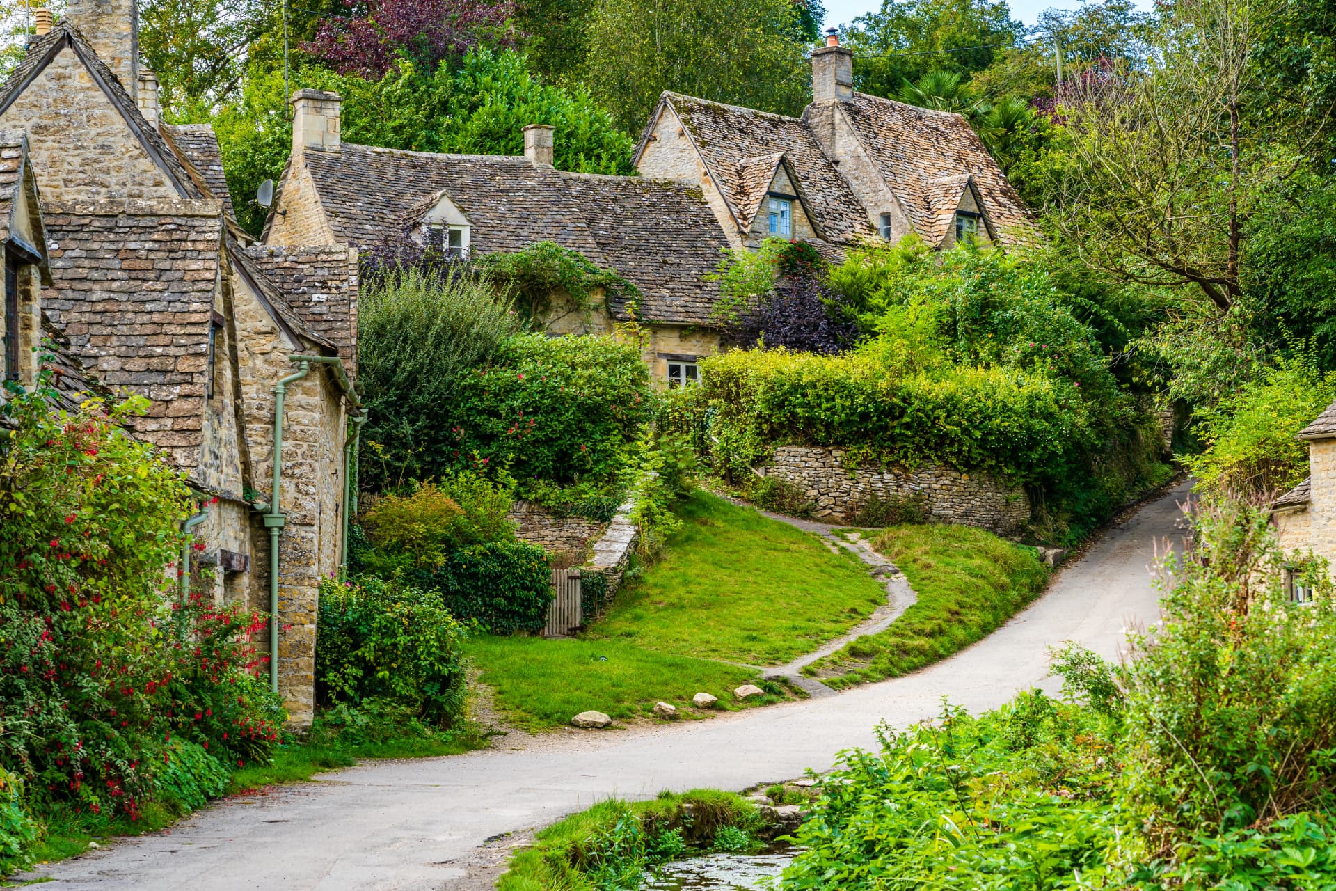 Traditional row of stone cottage houses on Arlington Row in Bibury village, Gloucestershire, The Cotswolds, England UK