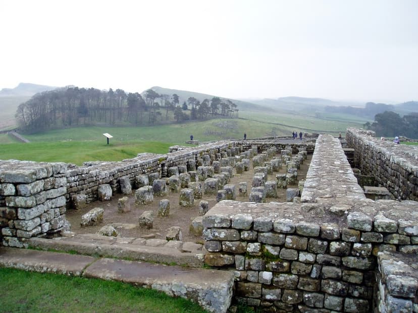 Hadrian's Wall Housesteads Fort stone ruins with hypocaust pillars overlooking rolling green hills