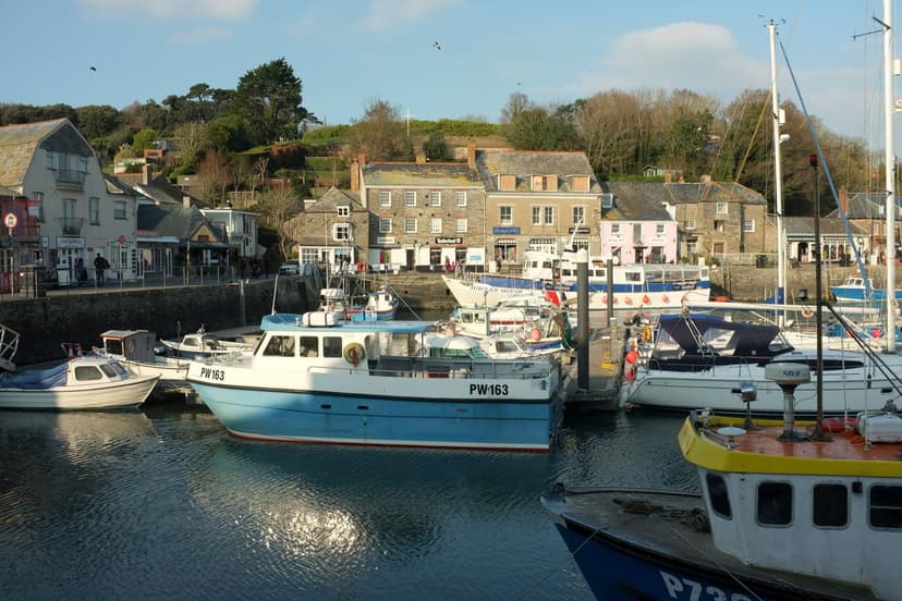 Padstow harbor in Cornwall with moored boats and waterfront buildings