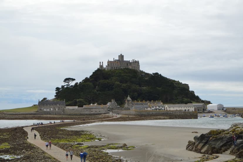 St. Michael's Mount tidal causeway with people walking and historic castle on island hill