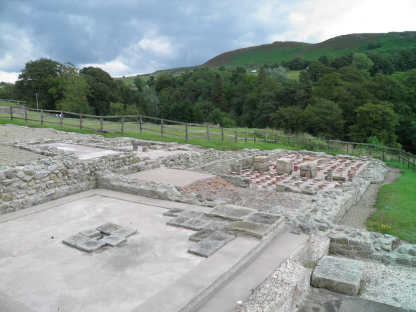 Hadrian's Wall archaeological ruins at Vindolanda with hypocaust and green hills in background