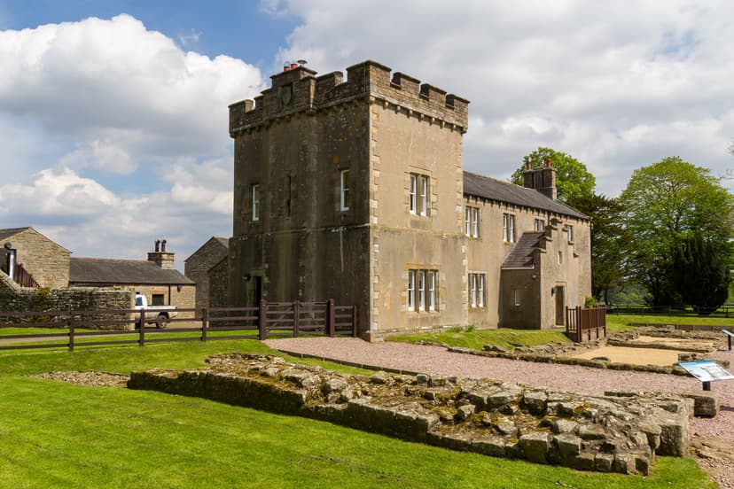 Hadrian's Wall Birdoswald Fort stone tower and historic ruins with grassy lawn