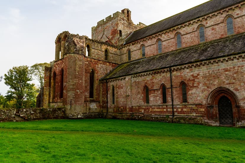 Lanercost Priory red sandstone medieval church ruins near Hadrian's Wall with grass lawn